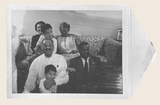 Polaroid of Thurgood Marshall at home in Harlem with his sons, John W. Marshall in his lap and Thurgood Marshall Jr behind, his Aunt Medi, and close family friends Monroe Dowling and Helen Dowling.